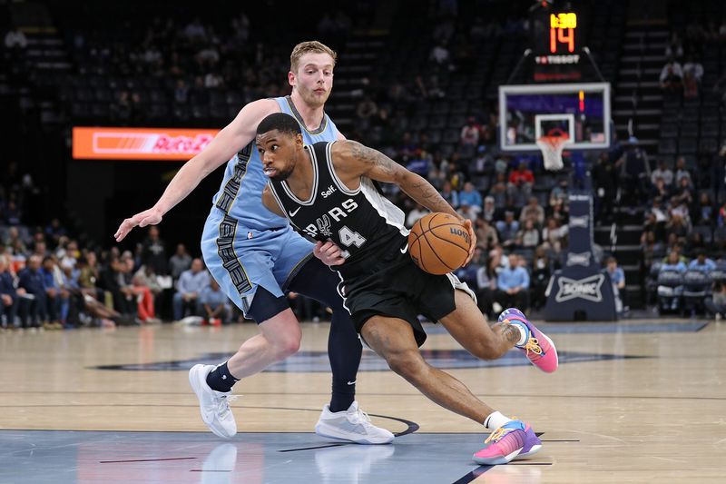 MEMPHIS, TENNESSEE - APRIL 09: Blake Wesley #14 of the San Antonio Spurs goes to the basket against Jack White #14 of the Memphis Grizzlies during the second half at FedExForum on April 09, 2024 in Memphis, Tennessee. NOTE TO USER: User expressly acknowledges and agrees that, by downloading and or using this photograph, User is consenting to the terms and conditions of the Getty Images License Agreement. (Photo by Justin Ford/Getty Images)