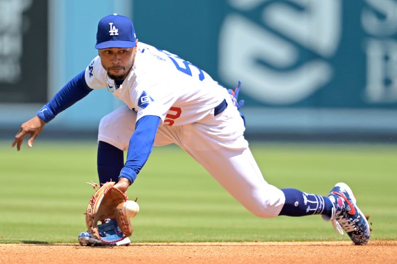 Apr 17, 2024; Los Angeles, California, USA; Los Angeles Dodgers shortstop Mookie Betts (50) makes a play and throws Washington Nationals second base Luis García Jr. (2) out at first in the third inning at Dodger Stadium. Mandatory Credit: Jayne Kamin-Oncea-USA TODAY Sports