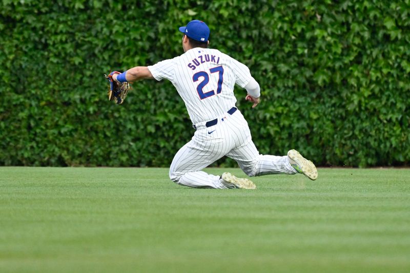 May 16, 2024; Chicago, Illinois, USA;  Chicago Cubs outfielder Seiya Suzuki (27) catches a fly ball hit by Pittsburgh Pirates second base Nick Gonzales (not pictured) during the first inning at Wrigley Field. Mandatory Credit: Matt Marton-USA TODAY Sports