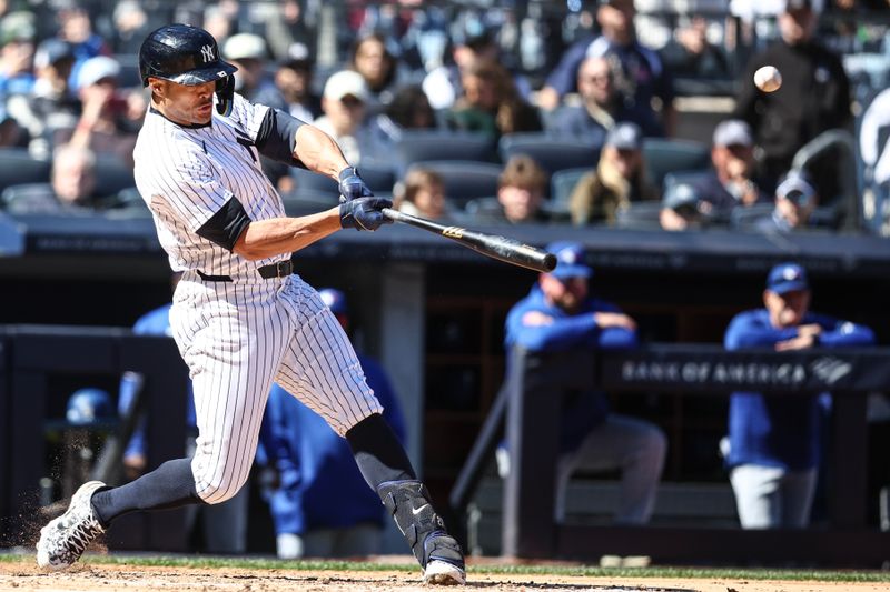 Apr 7, 2024; Bronx, New York, USA; New York Yankees designated hitter Giancarlo Stanton (27) hits a grand slam home run in the third inning against the Toronto Blue Jays at Yankee Stadium. Mandatory Credit: Wendell Cruz-USA TODAY Sports