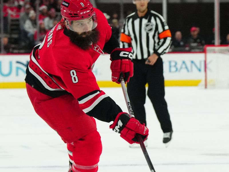 Dec 23, 2023; Raleigh, North Carolina, USA; Carolina Hurricanes defenseman Brent Burns (8) takes a shot against the New York Islanders during the first period at PNC Arena. Mandatory Credit: James Guillory-USA TODAY Sports