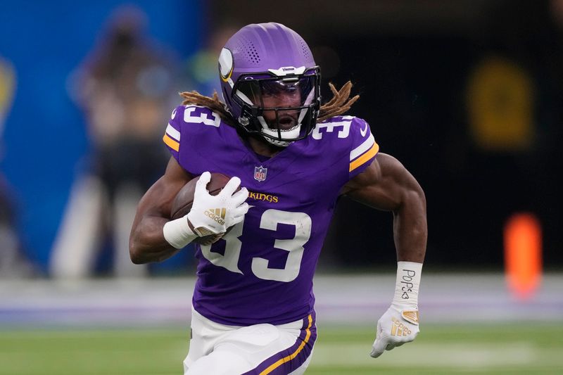 Minnesota Vikings running back Aaron Jones (33) runs with the football during the first half of an NFL football game against the Los Angeles Rams, Thursday, Oct. 24, 2024, in Inglewood, Calif. (AP Photo/Mark J. Terrill)