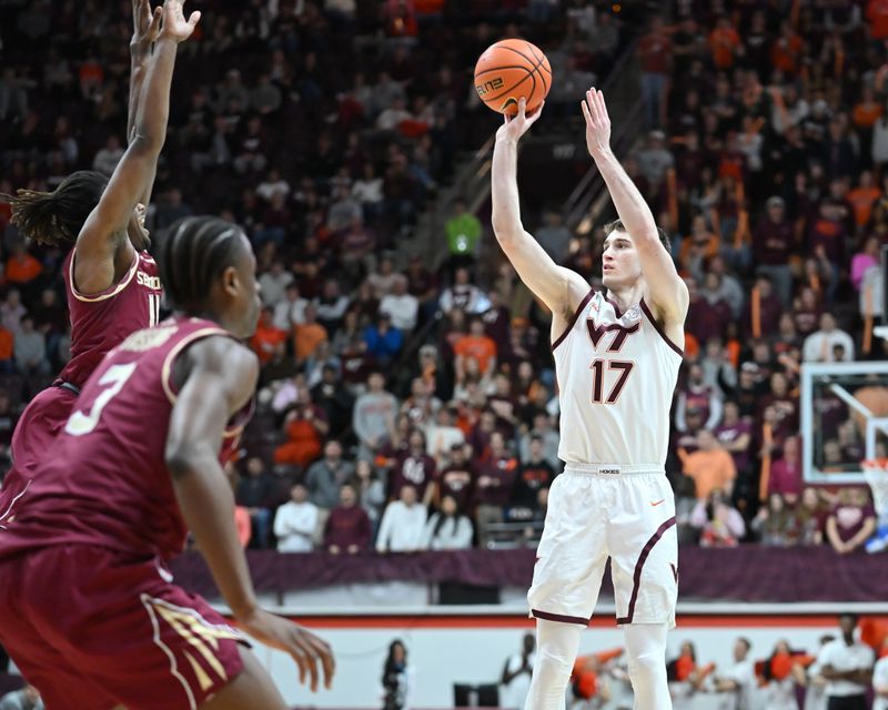 Feb 14, 2026; Blacksburg, Virginia, USA;  Virginia Tech Hokies guard Neoklis Avdalas (17) shoots shoots as Florida State Seminoles guard Xavier Osceola (11) defends during the second half at Cassell Coliseum. Mandatory Credit: Brian Bishop-Imagn Images
