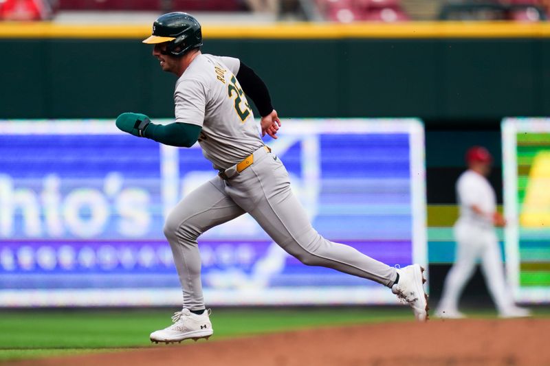 Aug 29, 2024; Cincinnati, Ohio, USA;  Oakland Athletics designated hitter Brent Rooker (25) runs to third base during the first inning of the MLB game between the Cincinnati Reds and Oakland Athletics, Thursday, Aug. 29, 2024, at Cintas Center in Cincinnati. Mandatory Credit: Frank Bowen IV/The Cincinnati Enquirer-USA TODAY Sports