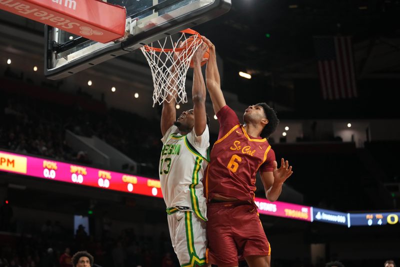 Feb 21, 2026; Los Angeles, California, USA; Southern California Trojans forward Jacob Cofie (6) blocks a sjot by Oregon Ducks forward Sean Stewart (13) in the first half at Galen Center. Mandatory Credit: Kirby Lee-Imagn Images