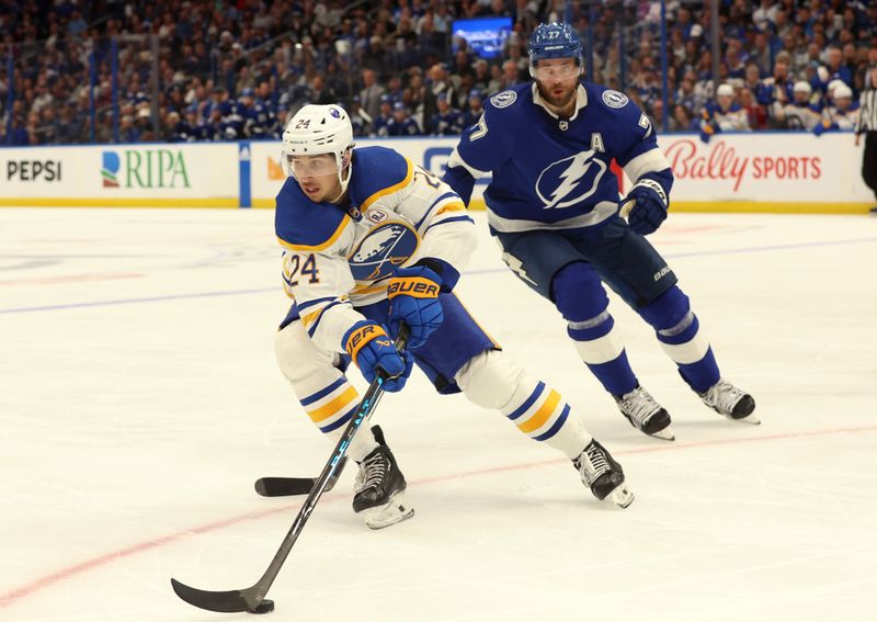 Apr 15, 2024; Tampa, Florida, USA; Buffalo Sabres center Dylan Cozens (24) skates with the puck as Tampa Bay Lightning defenseman Victor Hedman (77) defends during the second period at Amalie Arena. Mandatory Credit: Kim Klement Neitzel-USA TODAY Sports