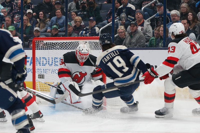 Mar 17, 2025; Columbus, Ohio, USA; New Jersey Devils goalie Jake Allen (34) makes a save on the shot from Columbus Blue Jackets center Adam Fantilli (19) during the first period at Nationwide Arena. Mandatory Credit: Russell LaBounty-Imagn Images