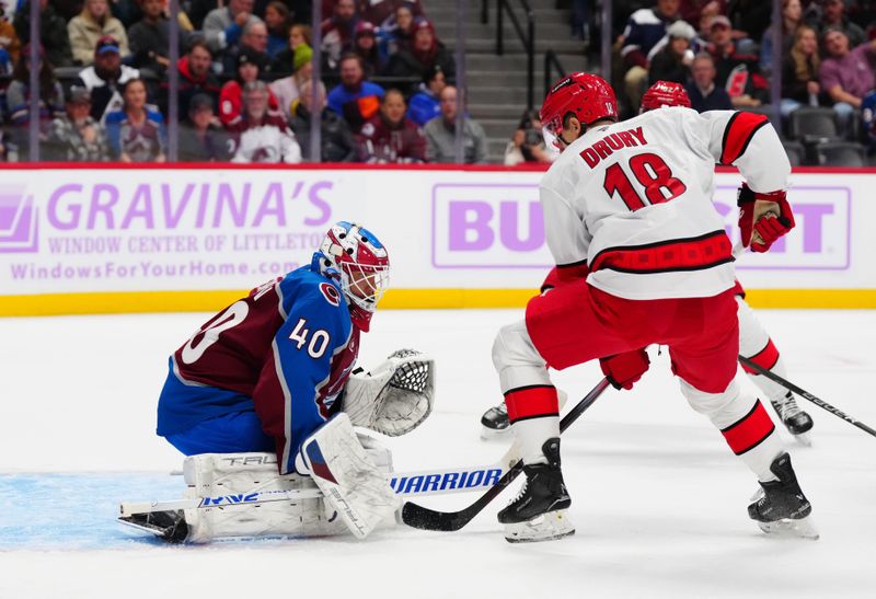 Nov 9, 2024; Denver, Colorado, USA; Carolina Hurricanes center Jack Drury (18) attempts to score on Colorado Avalanche goaltender Alexandar Georgiev (40) in the first period at Ball Arena. Mandatory Credit: Ron Chenoy-Imagn Images