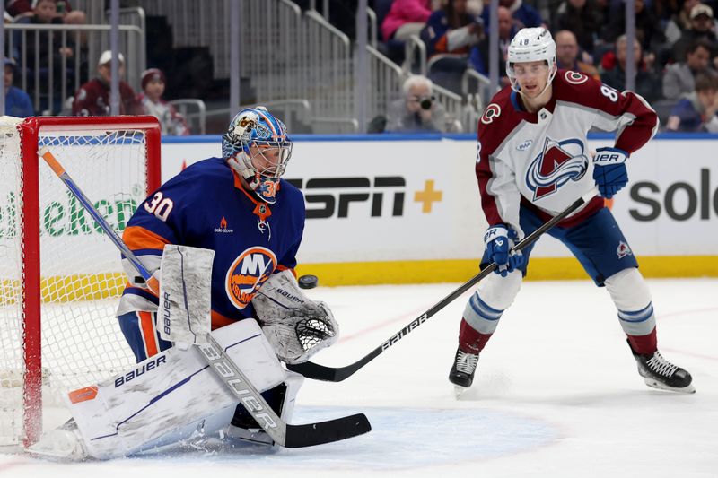 Jan 28, 2025; Elmont, New York, USA; New York Islanders goaltender Ilya Sorokin (30) makes a save in front of Colorado Avalanche center Martin Necas (88) during the first period at UBS Arena. Mandatory Credit: Brad Penner-Imagn Images