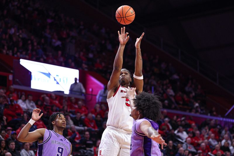 Feb 24, 2026; Piscataway, New Jersey, USA; Rutgers Scarlet Knights guard Darren Buchanan Jr. (5) shoots the ball as Washington Huskies center Lathan Sommerville (24) defends during the second half at Jersey Mike's Arena. Mandatory Credit: Vincent Carchietta-Imagn Images