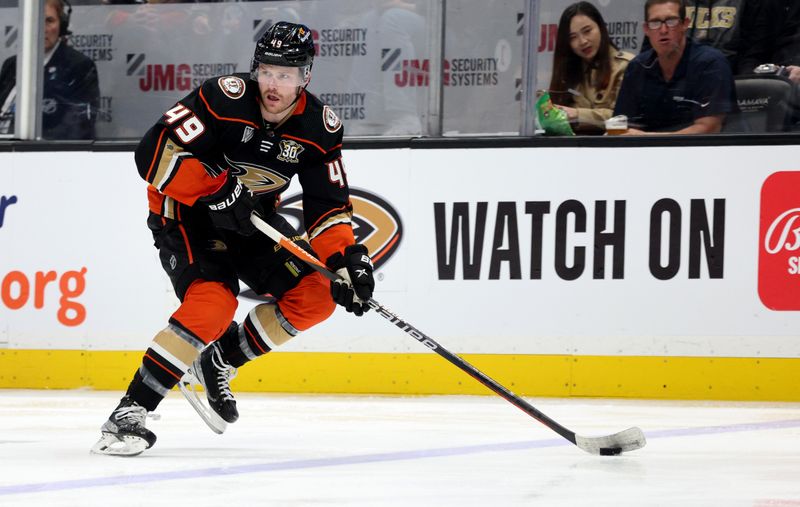 Mar 24, 2024; Anaheim, California, USA; Anaheim Ducks left wing Max Jones (49) skates with the puck during the second period against the Tampa Bay Lightning at Honda Center. Mandatory Credit: Jason Parkhurst-USA TODAY Sports