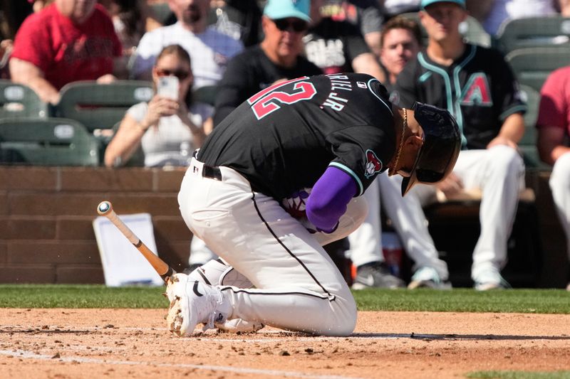 Mar 8, 2024; Salt River Pima-Maricopa, Arizona, USA; Arizona Diamondbacks left fielder Lourdes Gurriel Jr. (12) reacts after getting hit with the pitch against the Chicago Cubs in the third inning at Salt River Fields at Talking Stick. Mandatory Credit: Rick Scuteri-USA TODAY Sports