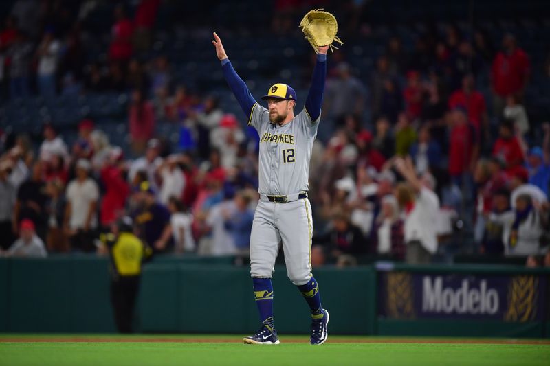 Jun 18, 2024; Anaheim, California, USA; Milwaukee Brewers first base Rhys Hoskins (12) reacts after outfielder Sal Frelick (10) catches the fly ball of Los Angeles Angels outfielder Taylor Ward (3) for the last out of the game at Angel Stadium. Mandatory Credit: Gary A. Vasquez-USA TODAY Sports