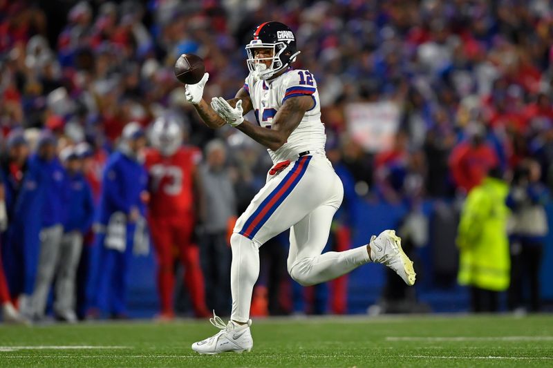 New York Giants tight end Darren Waller (12) makes a catch during the second half of an NFL football game against the Buffalo Bills in Orchard Park, N.Y., Sunday, Oct. 15, 2023. (AP Photo/Adrian Kraus)