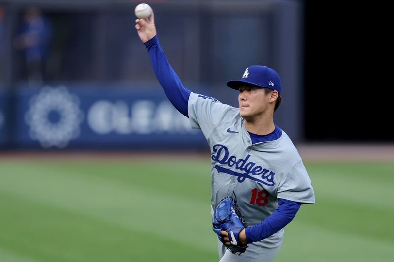 Jun 7, 2024; Bronx, New York, USA; Los Angeles Dodgers starting pitcher Yoshinobu Yamamoto (18) warms up before his start against the New York Yankees at Yankee Stadium. Mandatory Credit: Brad Penner-USA TODAY Sports