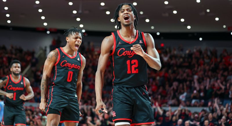 Feb 22, 2023; Houston, Texas, USA; Houston Cougars guard Tramon Mark (12) reacts with guard Marcus Sasser (0) after a play during the second half against the Tulane Green Wave at Fertitta Center. Mandatory Credit: Troy Taormina-USA TODAY Sports