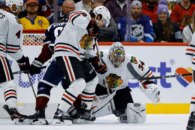 Oct 28, 2024; Denver, Colorado, USA; Chicago Blackhawks defenseman TJ Brodie (78) clears the puck from in front of goaltender Petr Mrazek (34) as Colorado Avalanche right wing Nikolai Kovalenko (51) battles for position in the third period at Ball Arena. Mandatory Credit: Isaiah J. Downing-Imagn Images