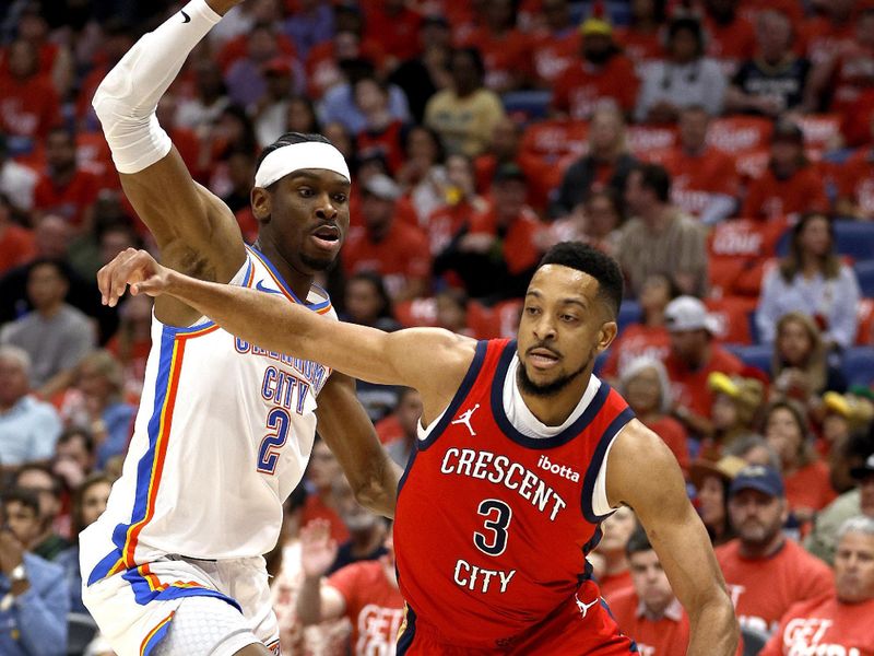 NEW ORLEANS, LOUISIANA - APRIL 27: CJ McCollum #3 of the New Orleans Pelicans dirbbles past Shai Gilgeous-Alexander #2 of the Oklahoma City Thunder during the first quarter of Game Three of the first round of the 2024 NBA Playoffs at Smoothie King Center on April 27, 2024 in New Orleans, Louisiana. NOTE TO USER: User expressly acknowledges and agrees that, by downloading and or using this photograph, User is consenting to the terms and conditions of the Getty Images License Agreement. (Photo by Sean Gardner/Getty Images)