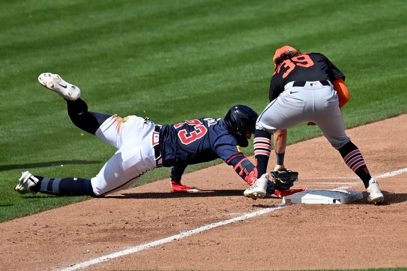 Mar 5, 2024; North Port, Florida, USA;  Atlanta Braves left fielder Forrest Wall (73) hangs onto third base as Detroit Tigers third baseman Zach McKinstry (39) attempts to place the tag in the third inning of the spring training game at CoolToday Park. Mandatory Credit: Jonathan Dyer-USA TODAY Sports