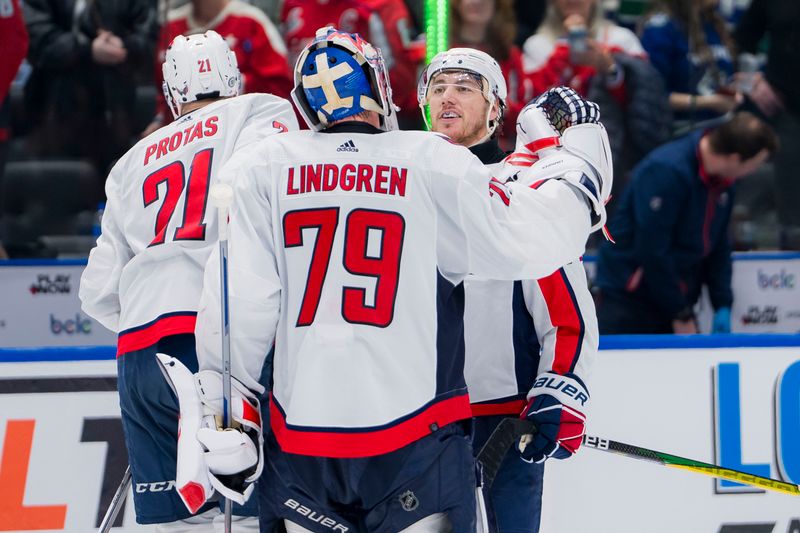 Mar 16, 2024; Vancouver, British Columbia, CAN; Washington Capitals forward Aliaksei Protas (21) and forward TJ Oshie (77) and goalie Charlie Lindgren (79) celebrate thier victory against the Vancouver Canucks at Rogers Arena. Washington won 2 -1. Mandatory Credit: Bob Frid-USA TODAY Sports