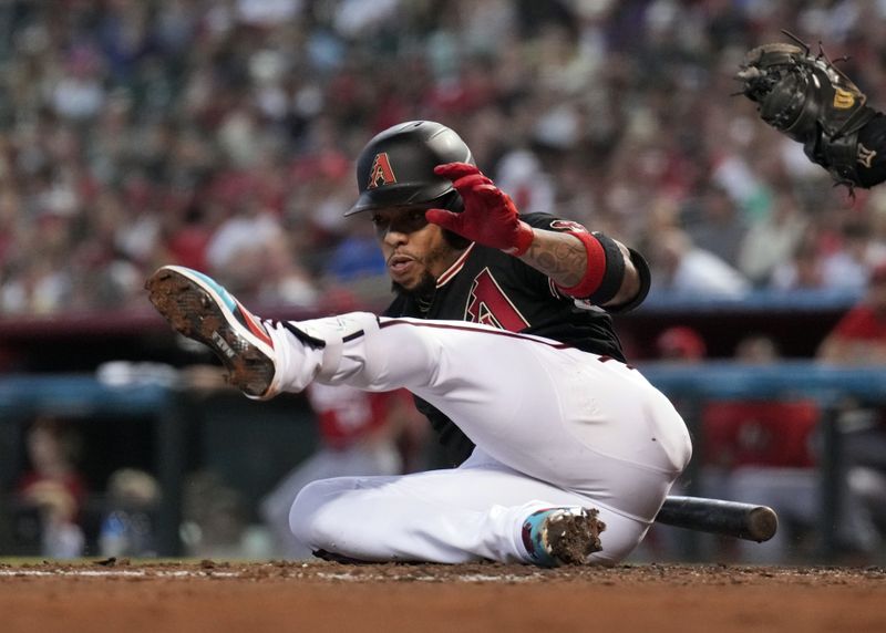 Aug 26, 2023; Phoenix, Arizona, USA; Arizona Diamondbacks second baseman Ketel Marte (4) hits the floor as he draws a walk against the Cincinnati Reds during the third inning at Chase Field. Mandatory Credit: Joe Camporeale-USA TODAY Sports