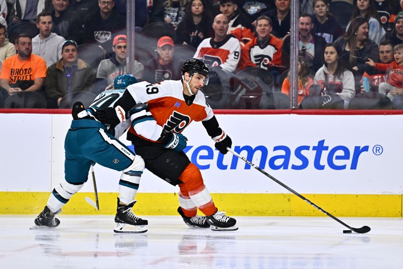 Mar 12, 2024; Philadelphia, Pennsylvania, USA; Philadelphia Flyers right wing Garnet Hathaway (19) pushes the puck past San Jose Sharks left wing Fabian Zetterlund (20) in the first period at Wells Fargo Center. Mandatory Credit: Kyle Ross-USA TODAY Sports