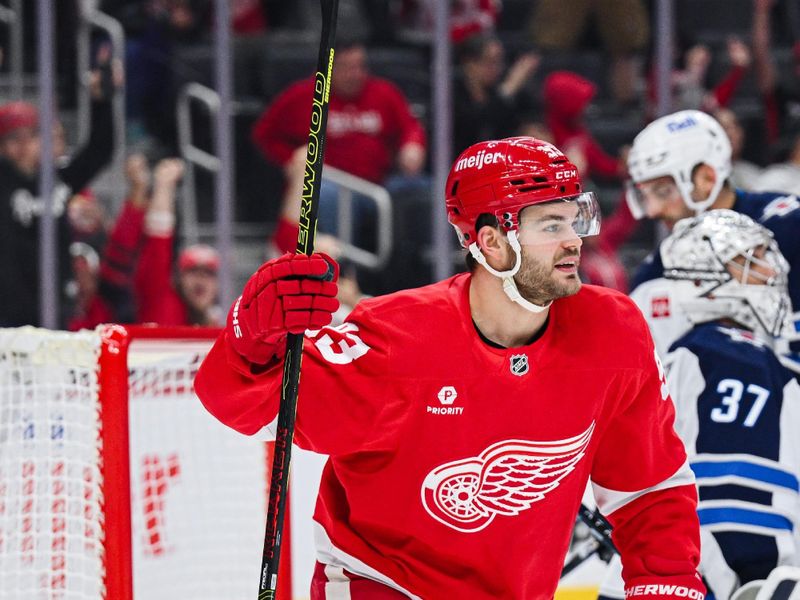 Oct 30, 2024; Detroit, Michigan, USA; Detroit Red Wings right wing Alex DeBrincat (93) celebrates center Dylan Larkin (not pictured) goal during the second period against the Winnipeg Jets at Little Caesars Arena. Mandatory Credit: Tim Fuller-Imagn Images