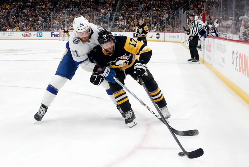 Apr 6, 2024; Pittsburgh, Pennsylvania, USA;  Pittsburgh Penguins right wing Bryan Rust (17) moves the puck against Tampa Bay Lightning defenseman Erik Cernak (81) during the third period at PPG Paints Arena. The Penguins won 5-4. Mandatory Credit: Charles LeClaire-USA TODAY Sports