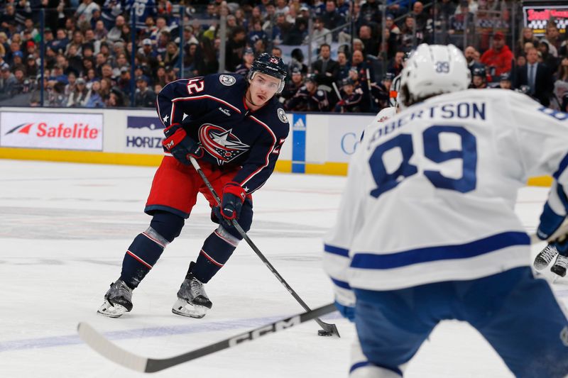 Dec 29, 2023; Columbus, Ohio, USA; Columbus Blue Jackets defenseman Jake Bean (22) passes the puck against the Toronto Maple Leafs during the first period at Nationwide Arena. Mandatory Credit: Russell LaBounty-USA TODAY Sports