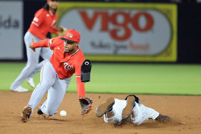 Feb 25, 2026; Tampa, Florida, USA; New York Yankees infielder Jonathan Ornelas (64) slides safe into second base as Washington Nationals left fielder Christian Franklin (33) attempts to tag him out during the fourth inning at George M. Steinbrenner Field. Mandatory Credit: Kim Klement Neitzel-Imagn Images