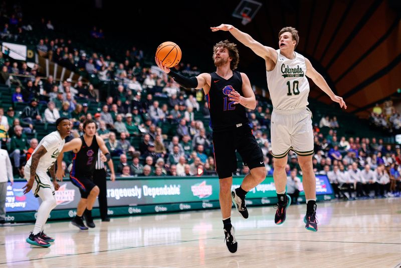 Feb 15, 2023; Fort Collins, Colorado, USA; Boise State Broncos guard Max Rice (12) drives to the net ahead of Colorado State Rams forward James Moors (10) in the first half at Moby Arena. Mandatory Credit: Isaiah J. Downing-USA TODAY Sports