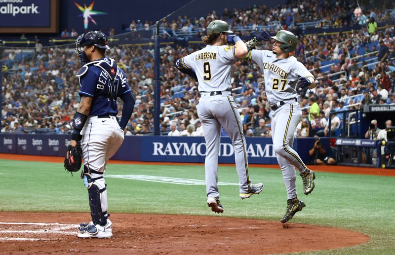 May 20, 2023; St. Petersburg, Florida, USA; Milwaukee Brewers third baseman Brian Anderson (9) is congratulated by shortstop Willy Adames (27)) after hitting a 2-run home run during the fourth inning against the Tampa Bay Rays at Tropicana Field. Mandatory Credit: Kim Klement-USA TODAY Sports