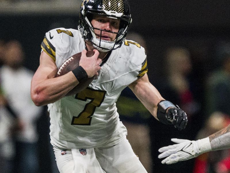 New Orleans Saints quarterback Taysom Hill (7) runs the ball during the first half of an NFL football game against the Atlanta Falcons, Sunday, Nov. 26, 2023, in Atlanta. The Atlanta Falcons won 24-15. (AP Photo/Danny Karnik)