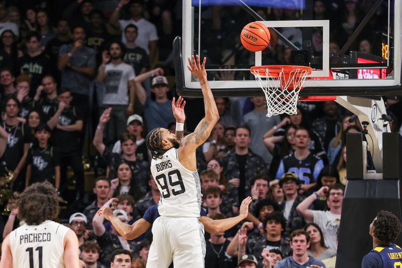 Feb 14, 2026; Orlando, Florida, USA; UCF Knights forward Jordan Burks (99) goes to the basket during the first half against the West Virginia Mountaineers at Addition Financial Arena. Mandatory Credit: Mike Watters-Imagn Images