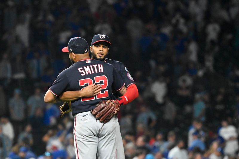 Jul 17, 2023; Chicago, Illinois, USA;  Washington Nationals first baseman Dominic Smith (22) is hugged by Washington Nationals third baseman Jeimer Candelario (9) after the game against the Chicago Cubs at Wrigley Field. Mandatory Credit: Matt Marton-USA TODAY Sports