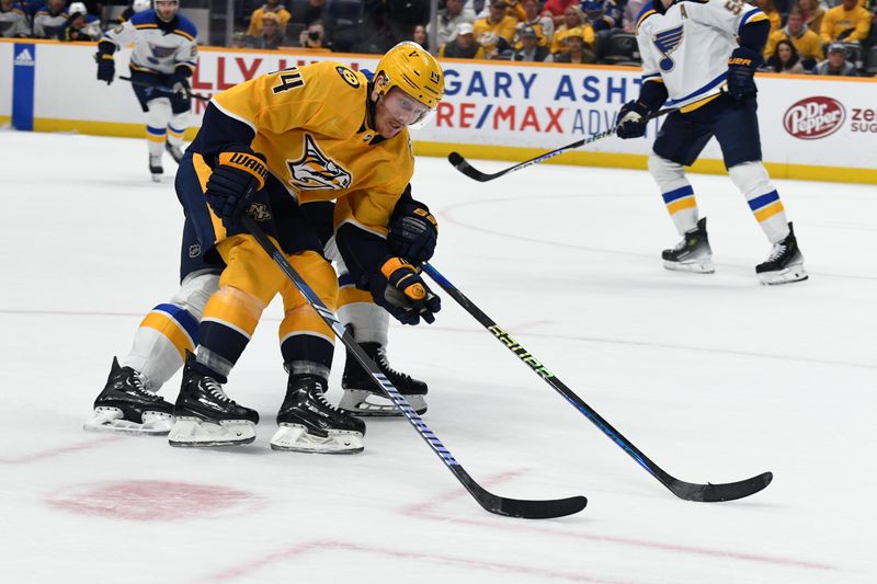 Apr 4, 2024; Nashville, Tennessee, USA; Nashville Predators center Gustav Nyquist (14) skates with the puck as he is defended by the St. Louis Blues during the first period at Bridgestone Arena. Mandatory Credit: Christopher Hanewinckel-USA TODAY Sports