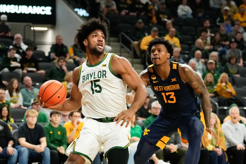 Feb 15, 2025; Waco, Texas, USA; Baylor Bears forward Norchad Omier (15) looks to score ahead of West Virginia Mountaineers forward Amani Hansberry (13) during the first half at Paul and Alejandra Foster Pavilion. Mandatory Credit: Chris Jones-Imagn Images