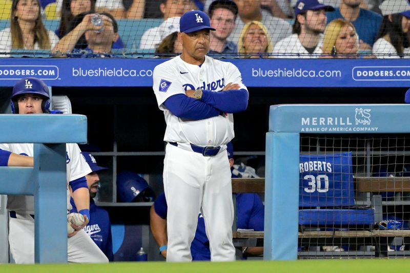 Jun 21, 2024; Los Angeles, California, USA;  Los Angeles Dodgers manager Dave Roberts (30) looks on from the dugout in the 10th inning against the Los Angeles Angels at Dodger Stadium. Mandatory Credit: Jayne Kamin-Oncea-USA TODAY Sports