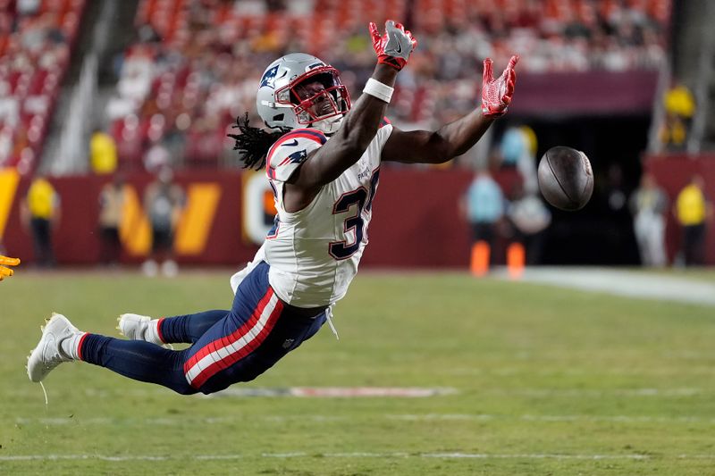 New England Patriots running back Deshaun Fenwick cannot catch a pass against the Washington Commanders during the second half of a preseason NFL football game, Sunday, Aug. 25, 2024, in Landover, Md. (AP Photo/George Walker IV)