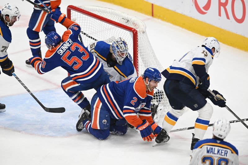 Apr 9, 2025; Edmonton, Alberta, CAN; Edmonton Oilers center Jeff Skinner (53) crashes into St. Louis Blues goalie Jordan Binnington (50) as Oilers defenseman Evan Bouchard (2) hits the ice during the third period at Rogers Place. Mandatory Credit: Walter Tychnowicz-Imagn Images
