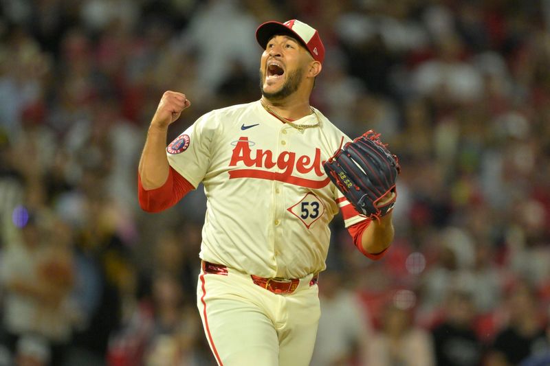 Jul 13, 2024; Anaheim, California, USA;  Carlos Estevez #53 of the Los Angeles Angels celebrates as he earns his 17th save of the season defeating the Seattle Mariners in the ninth inning at Angel Stadium. Mandatory Credit: Jayne Kamin-Oncea-USA TODAY Sports