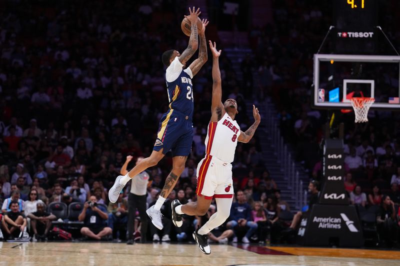 MIAMI, FLORIDA - OCTOBER 13: Jordan Hawkins #24 of the New Orleans Pelicans collects a pass against Josh Christopher #8 of the Miami Heat during the fourth quarter of a preseason game at Kaseya Center on October 13, 2024 in Miami, Florida. NOTE TO USER: User expressly acknowledges and agrees that, by downloading and or using this photograph, User is consenting to the terms and conditions of the Getty Images License Agreement. (Photo by Rich Storry/Getty Images)