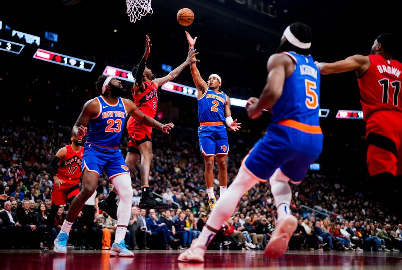 TORONTO, ON - MARCH 27: Miles McBride #2 of the New York Knicks puts up a shot against Jalen McDaniels #2 of the Toronto Raptors during the first half of their basketball game at the Scotiabank Arena on March 27, 2024 in Toronto, Ontario, Canada. NOTE TO USER: User expressly acknowledges and agrees that, by downloading and/or using this Photograph, user is consenting to the terms and conditions of the Getty Images License Agreement. (Photo by Mark Blinch/Getty Images)