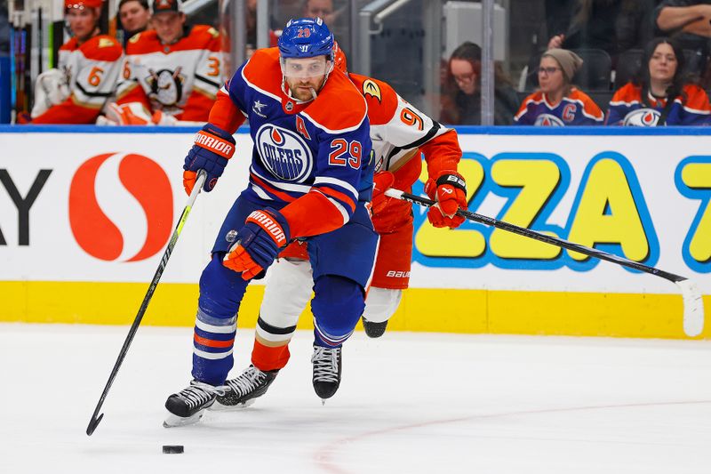 Jan 3, 2025; Edmonton, Alberta, CAN; Edmonton Oilers forward Leon Draisaitl (29) looks to make a play in front of forward Leo Carlsson (91) during the third period at Rogers Place. Mandatory Credit: Perry Nelson-Imagn Images