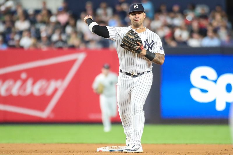 Aug 18, 2023; Bronx, New York, USA; New York Yankees second baseman Gleyber Torres (25) throws to first base to complete a double play in the fourth inning against the Boston Red Sox at Yankee Stadium. Mandatory Credit: Wendell Cruz-USA TODAY Sports