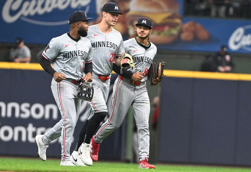 Apr 3, 2024; Milwaukee, Wisconsin, USA; Minnesota Twins outfielders Austin Martin (82), Manuel Margot (13) and Max Kepler (26) celebrate a 7-3 win over the Milwaukee Brewers at American Family Field. Mandatory Credit: Michael McLoone-USA TODAY Sports