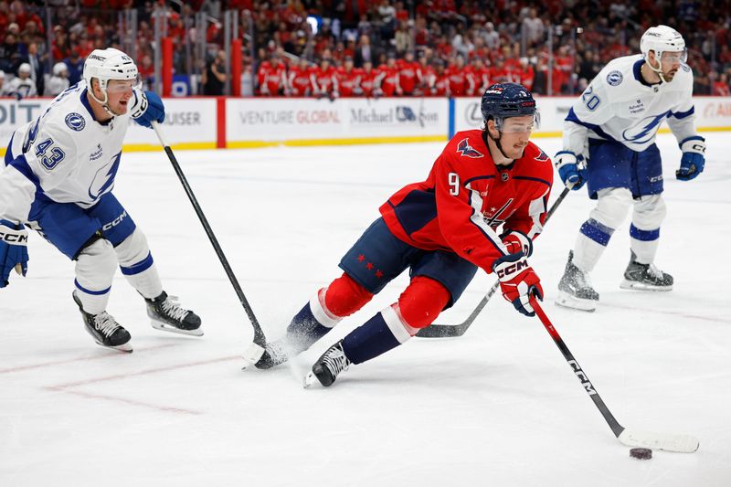 Nov 22, 2025; Washington, District of Columbia, USA; Washington Capitals right wing Ryan Leonard (9) skates with the puck against in front of Tampa Bay Lightning defenseman Darren Raddysh (43) during the third period at Capital One Arena. Mandatory Credit: Geoff Burke-Imagn Images