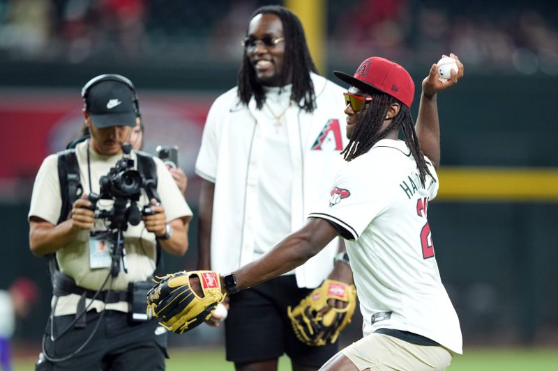 Jun 13, 2024; Phoenix, Arizona, USA; Marvin Harrison Jr. of the Arizona Cardinals throws out the first pitch prior to the game between the Arizona Diamondbacks and the Los Angeles Angels at Chase Field. Mandatory Credit: Joe Camporeale-USA TODAY Sports