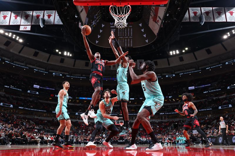 CHICAGO, IL - DECEMBER 13: Ayo Dosunmu #11 of the Chicago Bulls drives to the basket during the game against the Charlotte Hornets on December 13, 2024 at United Center in Chicago, Illinois. NOTE TO USER: User expressly acknowledges and agrees that, by downloading and or using this photograph, User is consenting to the terms and conditions of the Getty Images License Agreement. Mandatory Copyright Notice: Copyright 2024 NBAE (Photo by Jeff Haynes/NBAE via Getty Images)