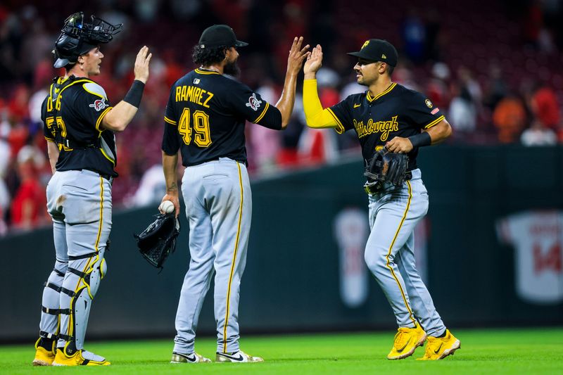 Sep 24, 2025; Cincinnati, Ohio, USA; Pittsburgh Pirates shortstop Nick Gonzales (39) high fives relief pitcher Yohan Ramirez (49) after the victory over the Cincinnati Reds at Great American Ball Park. Mandatory Credit: Katie Stratman-Imagn Images